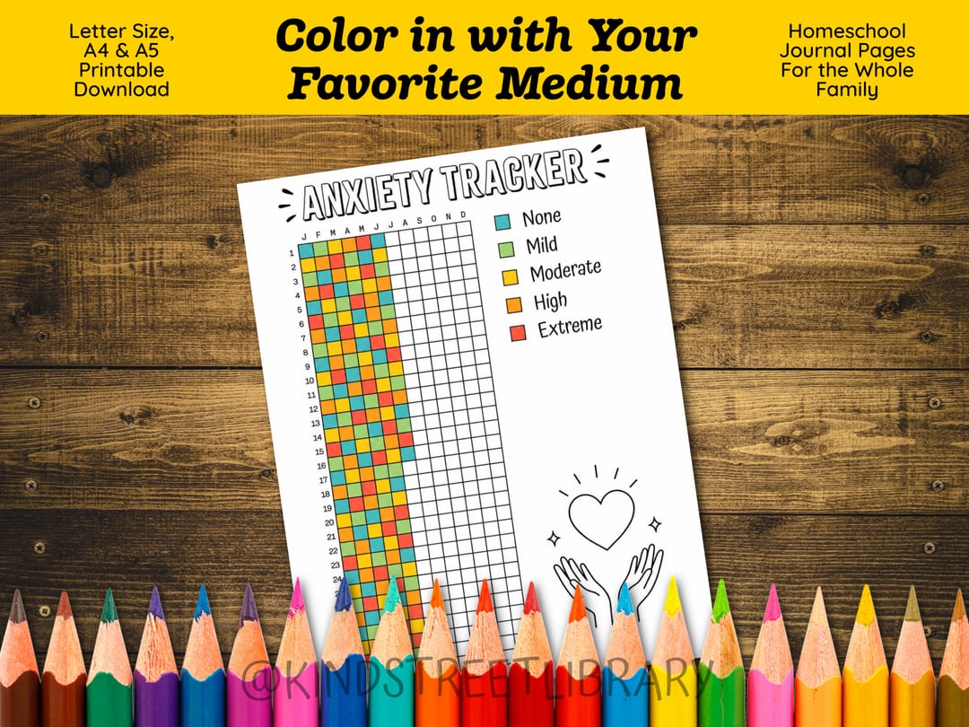 The pre-filled Anxiety Tracker resting on wood above a rainbow row of sharpened colored pencils, beneath the banner 'Color in with Your Favorite Medium'